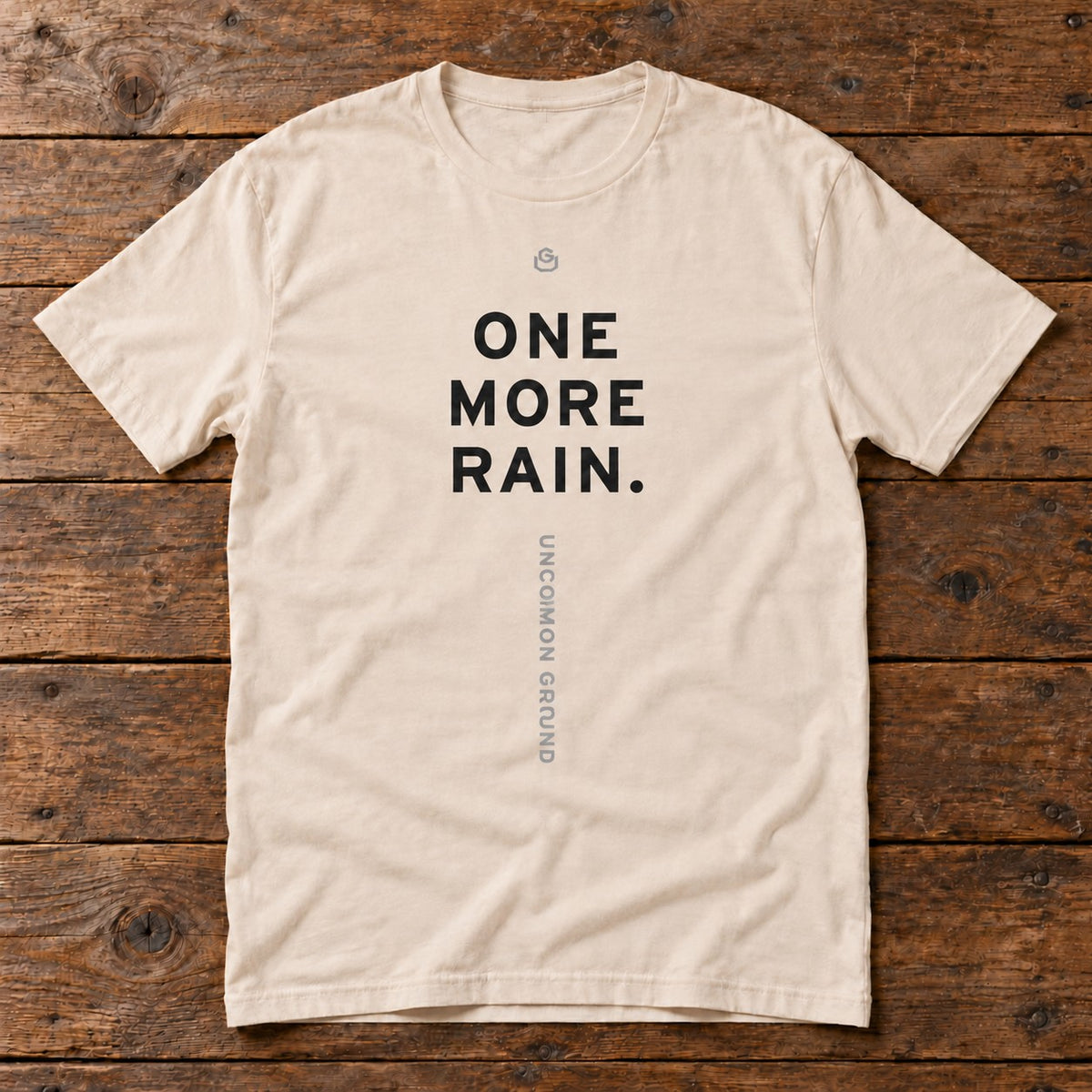 Front of the One More Rain Tee reading ONE MORE RAIN.