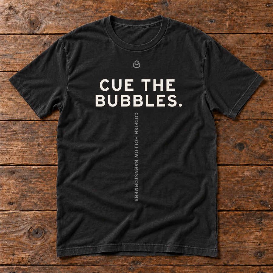 Front of the Cue the Bubbles Tee in black reading CUE THE BUBBLES.