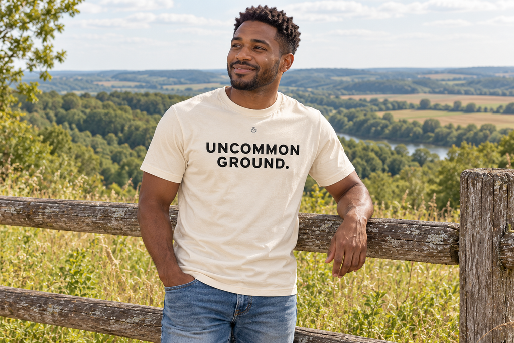 Front of the Uncommon Ground Tee reading UNCOMMON GROUND.
