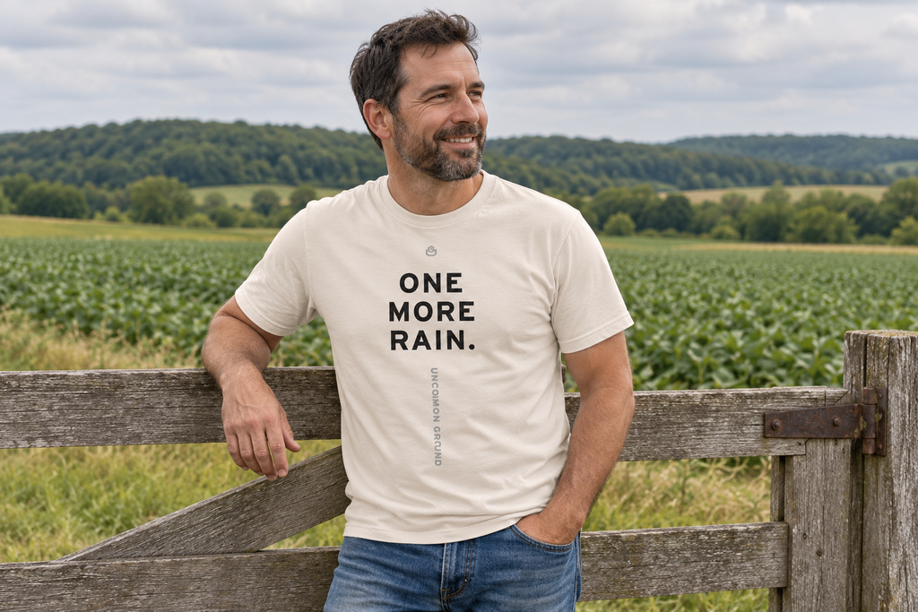 Front of the One More Rain Tee reading ONE MORE RAIN.