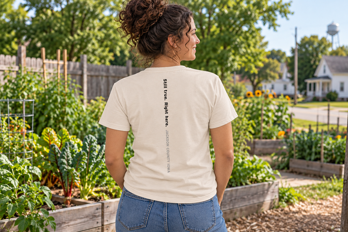 Back of the A Place to Grow Tee reading Still true. Right here. Jackson County Iowa