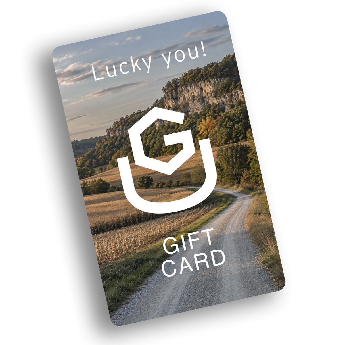 Uncommon Ground gift card with the UG mark over a gravel road and bluffs, reading Lucky you!